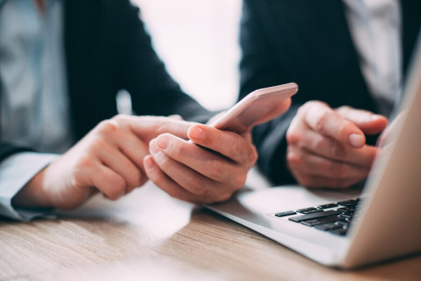 business person on mobile phone in hand